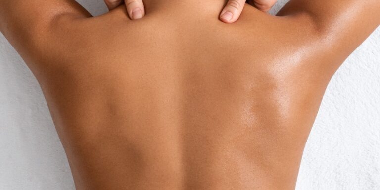 Female client receiving back & neck massage. Massage services provided by Fabulously Beautiful in Sutton Valence, Kent.